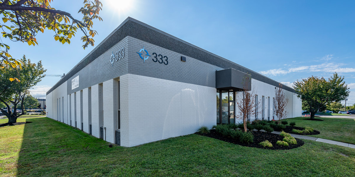 Exterior view of 333 Veterans Boulevard, showcasing the building's modern industrial design and surrounding landscape.