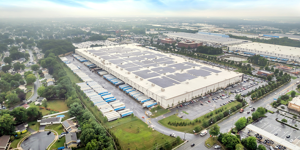 Aerial view of 2170 Lincoln Highway, Edison, NJ, showcasing the building and its rooftop solar panels.