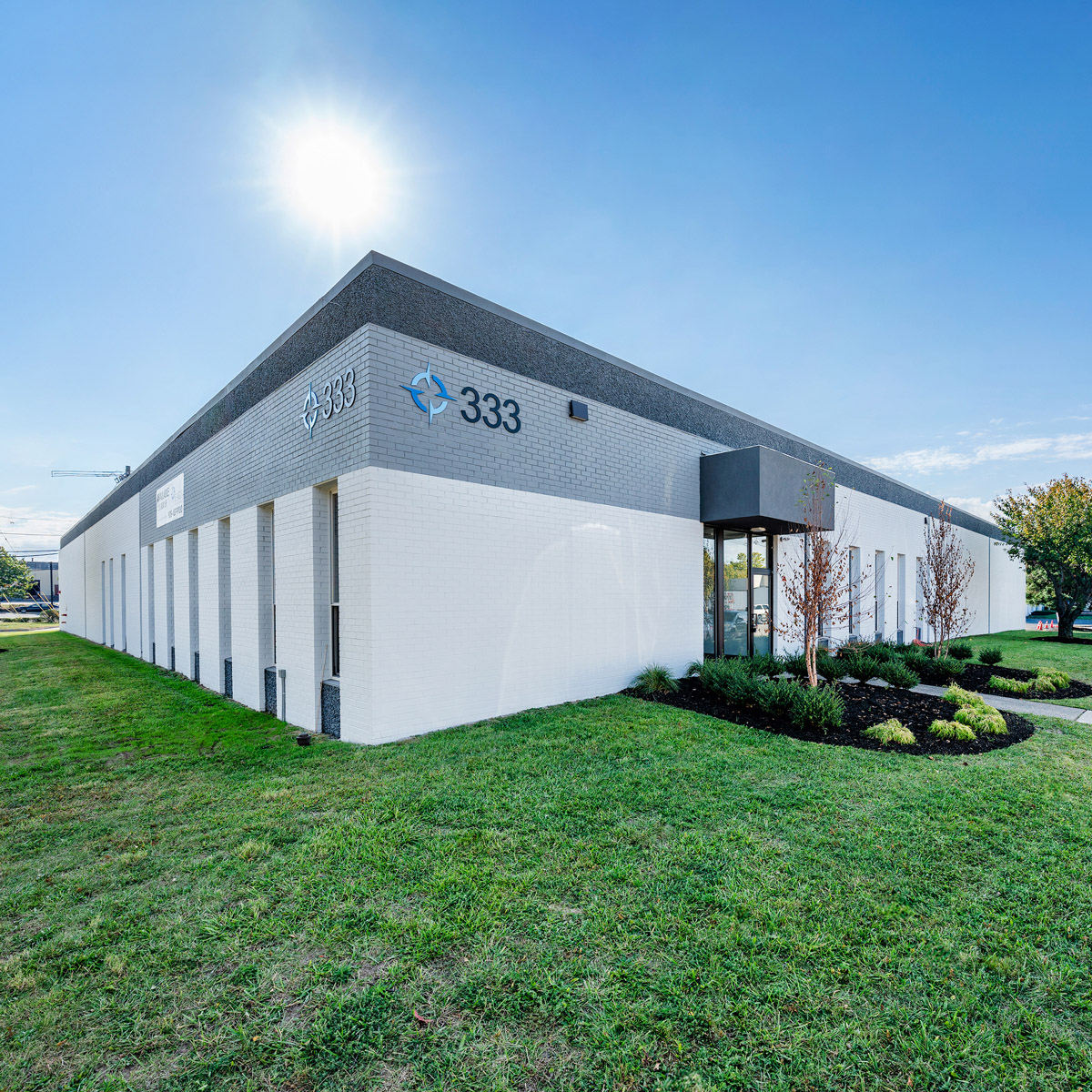 Exterior view of 333 Veterans Boulevard, showcasing the building's modern industrial design and surrounding landscape.