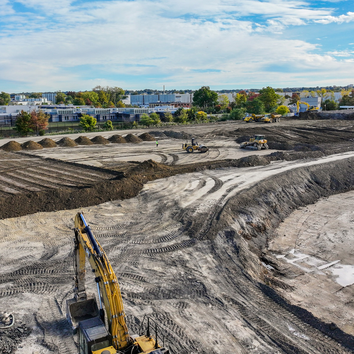 Construction site featuring land elevation machinery in operation, preparing the area for development.